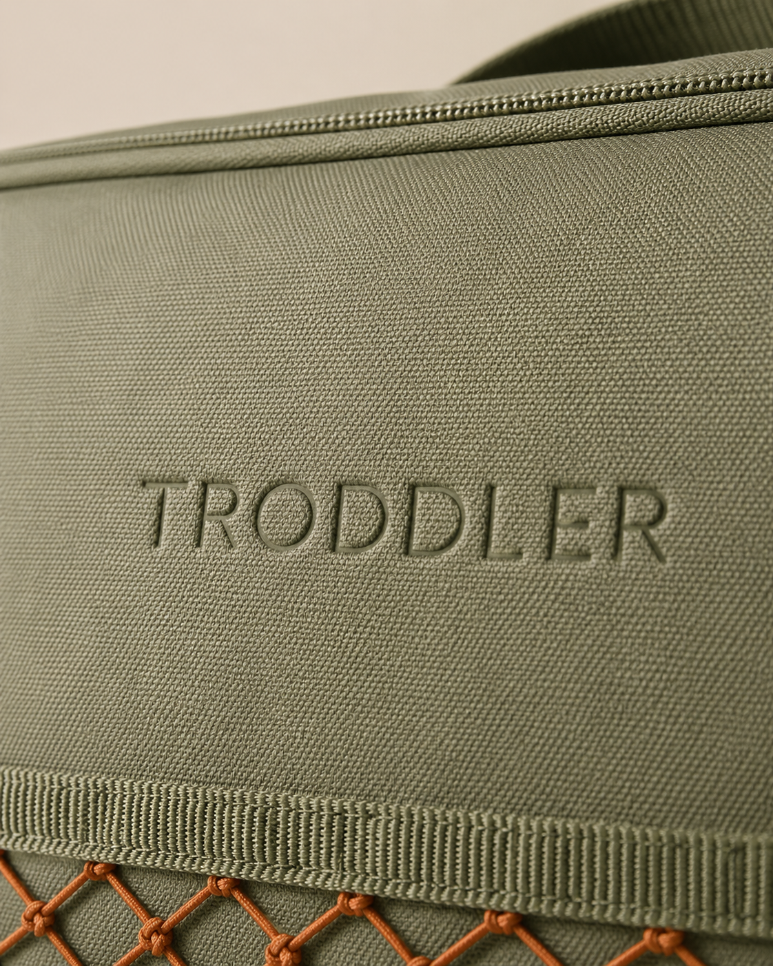 Debossed TRODDLER wordmark on canvas — detail